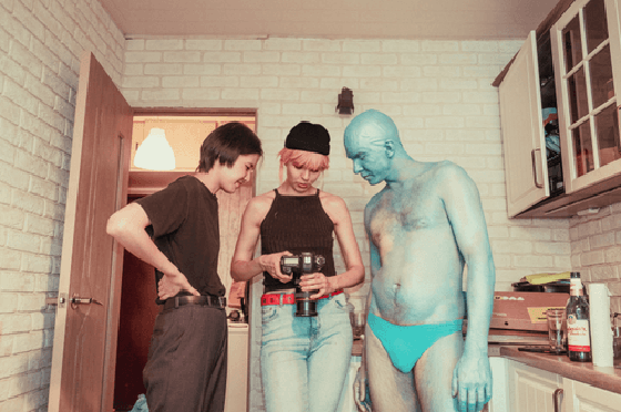 An ordinary person, CryptoPunk 2680 and CryptoPunk 3100 are looking at pictures