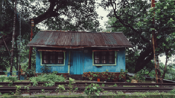 A rail, a road and a tiny blue house!