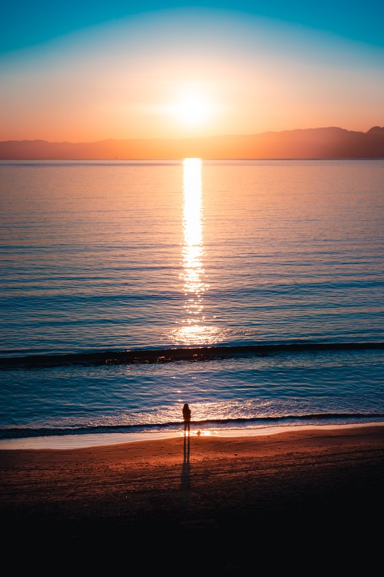 Girl watching the sunset alone.